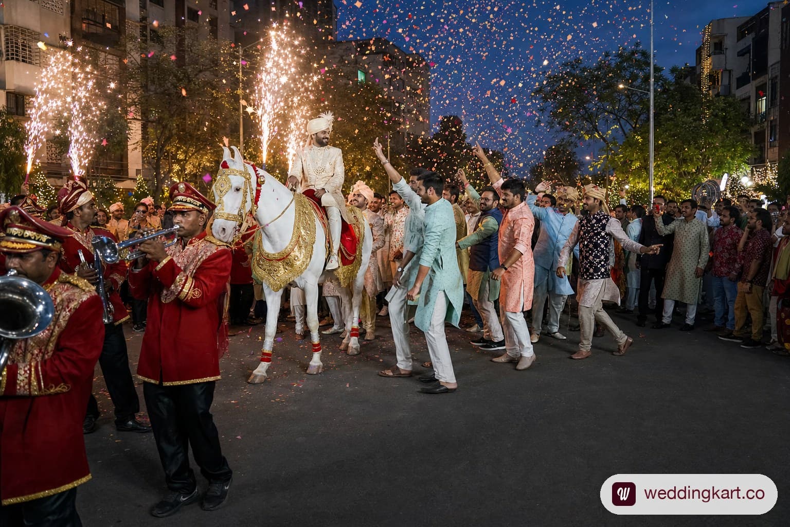 A vibrant Indian Baraat procession on an Ahmedabad street at dusk, with the groom in a cream sherwani and turban sitting atop a beautifully decorated white horse with golden and red adornments, family members dancing around the horse, and a brass band playing in front