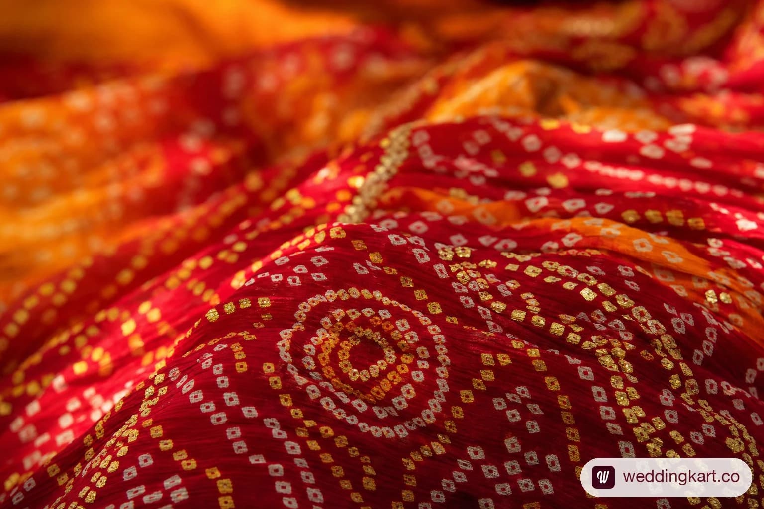 Bandhani tie-dye print fabric used for Gujarati chaniya choli in vibrant red and orange