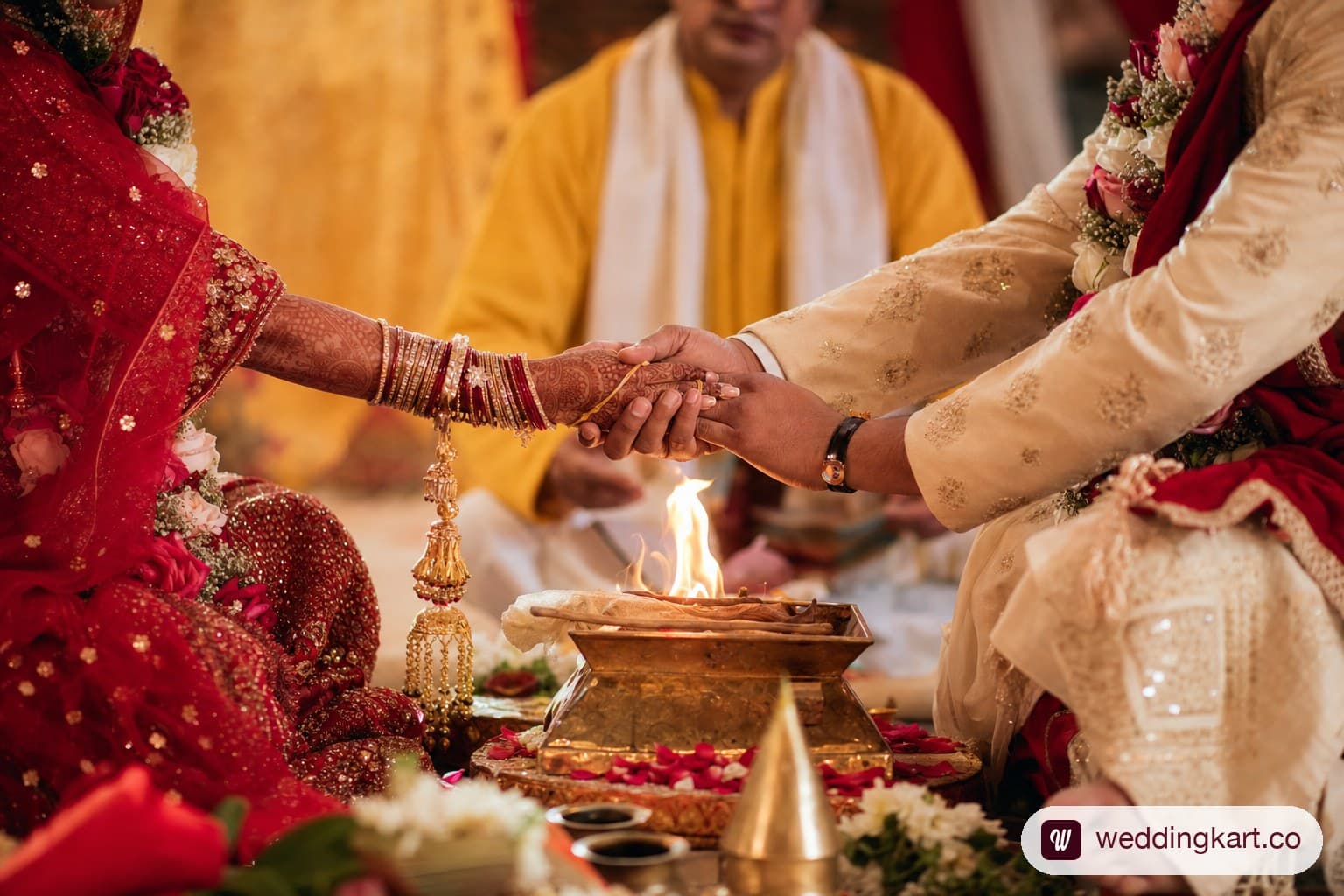 A decorated Hindu wedding mandap with the sacred fire and marigold garlands